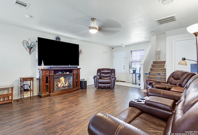 living room with dark hardwood / wood-style flooring and ceiling fan