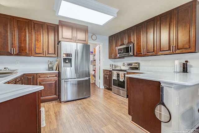 kitchen with light wood-type flooring and stainless steel appliances