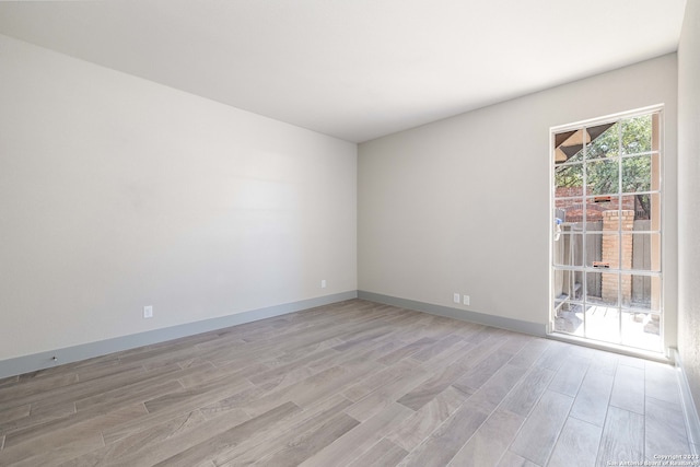 empty room with light hardwood / wood-style flooring