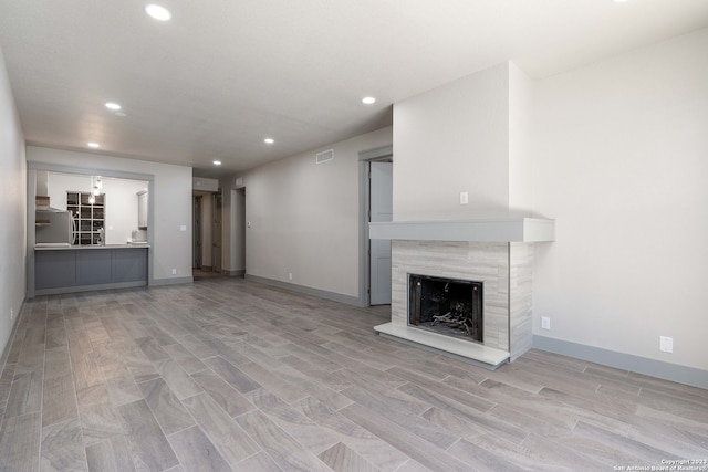 unfurnished living room with light hardwood / wood-style floors and a fireplace