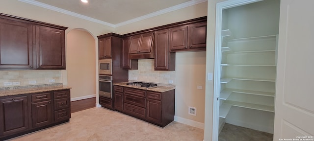 kitchen featuring tasteful backsplash, ornamental molding, appliances with stainless steel finishes, and light stone countertops