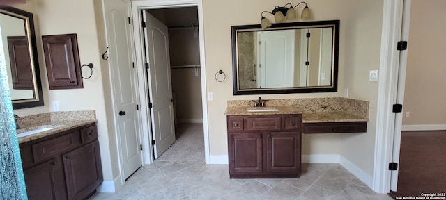 bathroom featuring tile flooring and double vanity