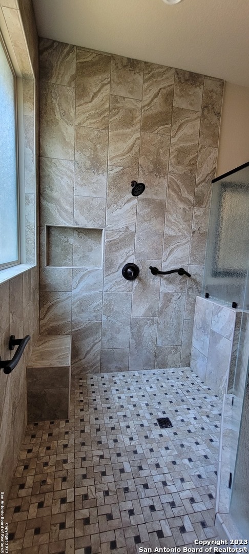 bathroom with a tile shower