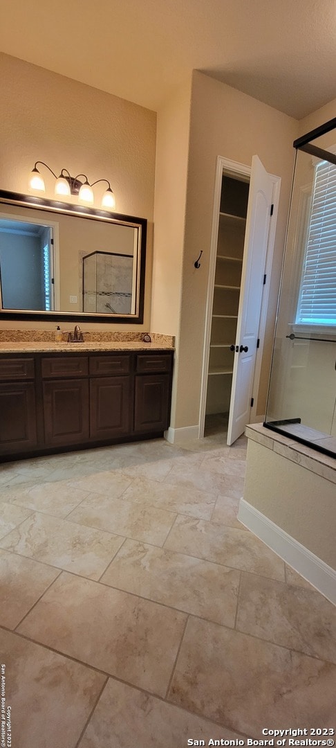 bathroom with vanity and tile flooring