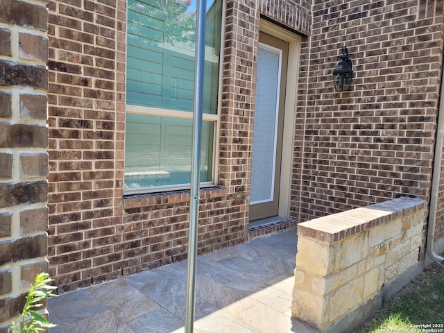 property entrance featuring a patio