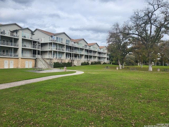 view of home's community featuring a lawn