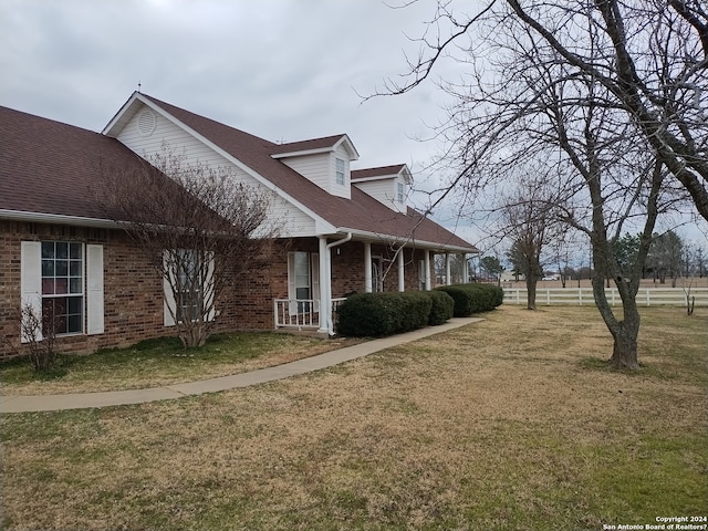 view of side of property featuring a lawn