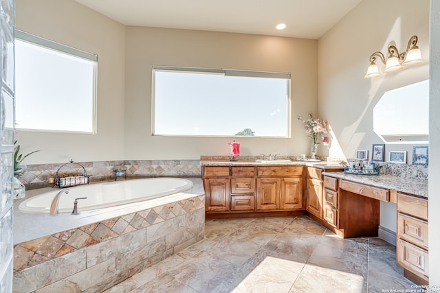 bathroom featuring a healthy amount of sunlight, a relaxing tiled bath, double sink vanity, and tile flooring