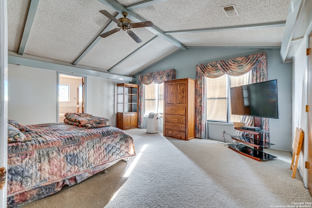 bedroom featuring light carpet, a textured ceiling, ceiling fan, and vaulted ceiling