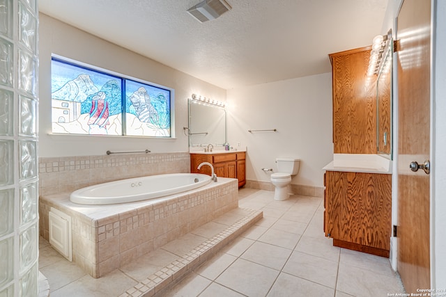 bathroom with tile floors, toilet, vanity, and a relaxing tiled bath