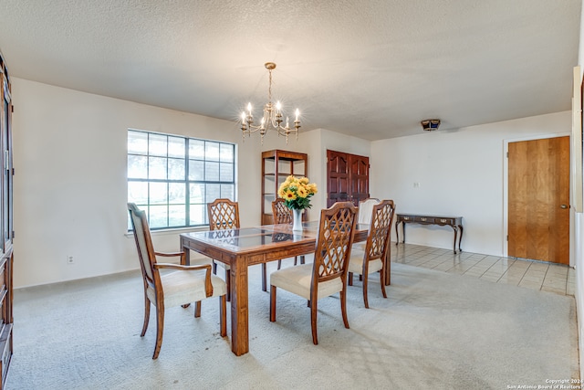 carpeted dining space featuring a notable chandelier and a textured ceiling