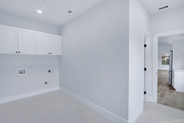 clothes washing area with washer hookup, gas dryer hookup, hookup for an electric dryer, cabinets, and light tile flooring