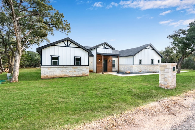 modern farmhouse style home with a front yard