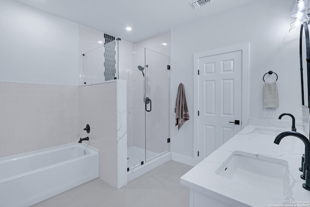 bathroom featuring dual vanity, tile flooring, and shower with separate bathtub