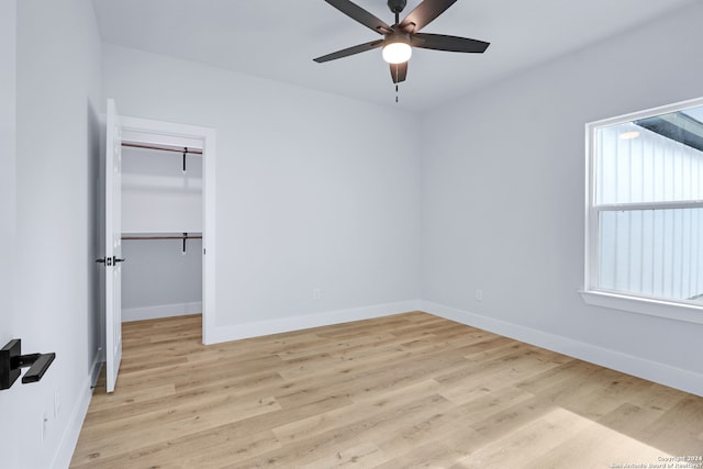 unfurnished room featuring plenty of natural light, ceiling fan, and light hardwood / wood-style flooring