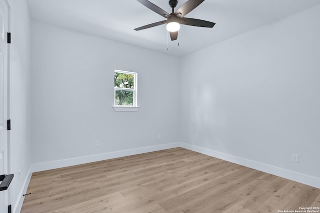 spare room with ceiling fan and light wood-type flooring