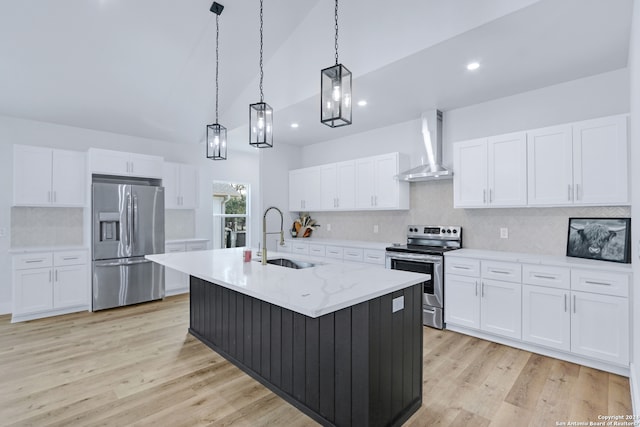 kitchen featuring light hardwood / wood-style floors, tasteful backsplash, stainless steel appliances, wall chimney exhaust hood, and sink