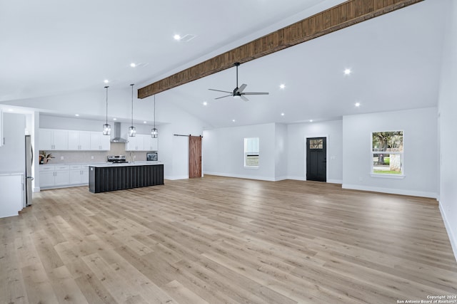 unfurnished living room featuring high vaulted ceiling, ceiling fan, light wood-type flooring, and beamed ceiling