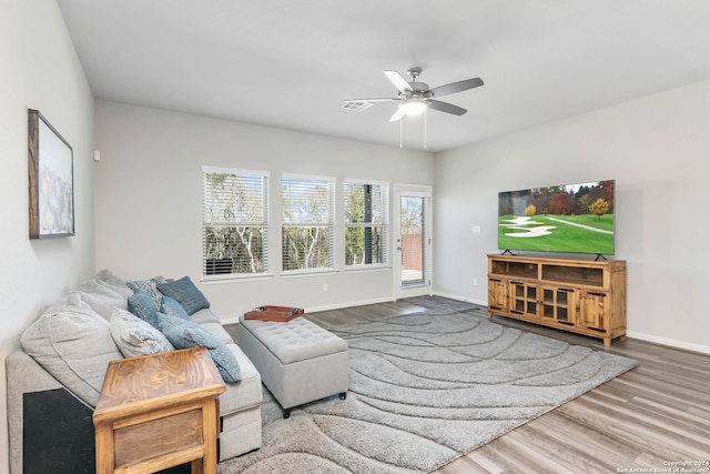 living room with hardwood / wood-style floors and ceiling fan