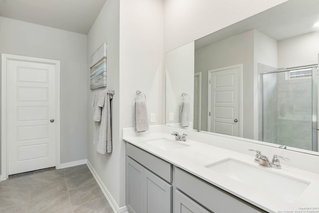 bathroom featuring a shower with door, tile flooring, and dual vanity