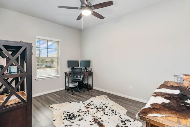 office space with dark wood-type flooring and ceiling fan