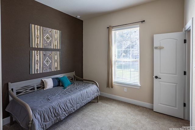 carpeted bedroom with multiple windows