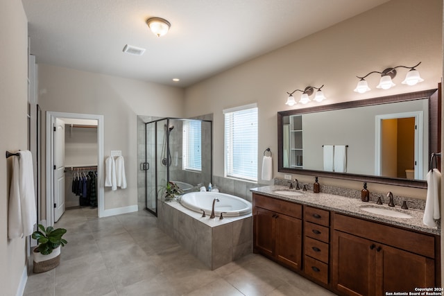 bathroom with shower with separate bathtub, double vanity, and tile flooring