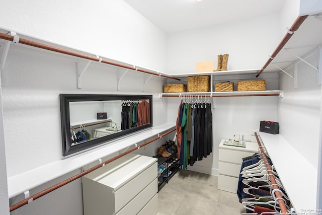 spacious closet with light tile flooring