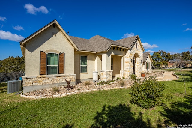 view of front facade with central AC unit and a front yard