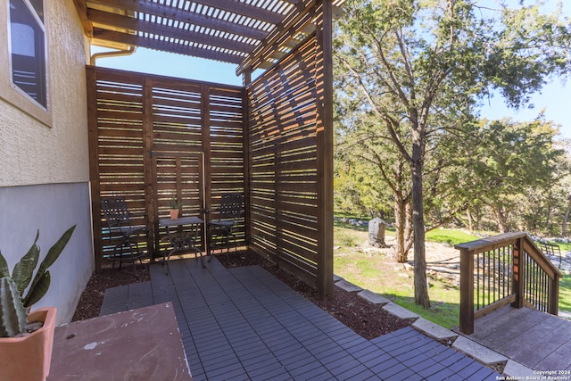 view of terrace with a wooden deck and a pergola