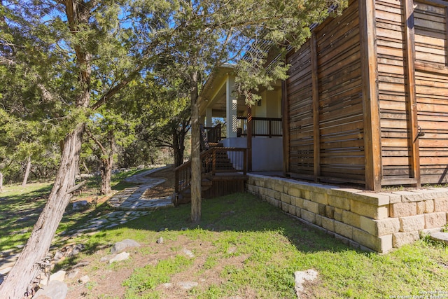 view of side of home with a lawn