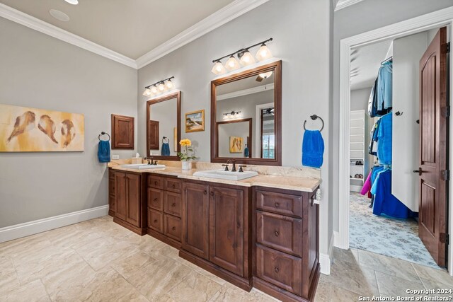 bathroom featuring ornamental molding, dual bowl vanity, and tile flooring