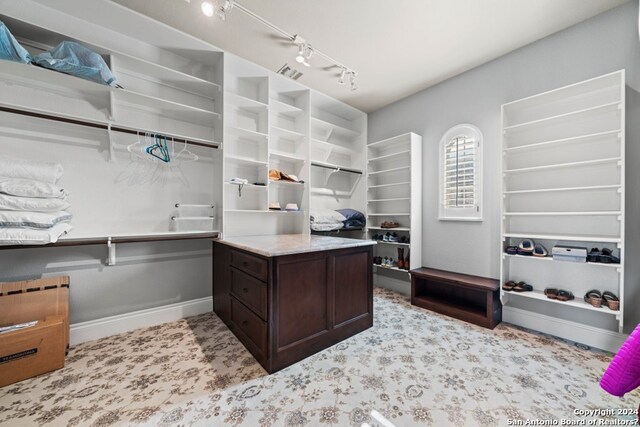 home office featuring light carpet and rail lighting