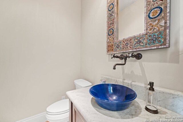 bathroom featuring toilet and vanity