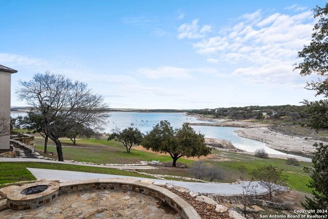 property view of water featuring an outdoor fire pit