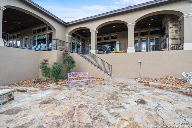 view of terrace featuring a balcony and ceiling fan