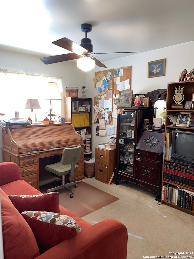 office area featuring light carpet and ceiling fan