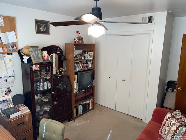 carpeted office featuring ceiling fan