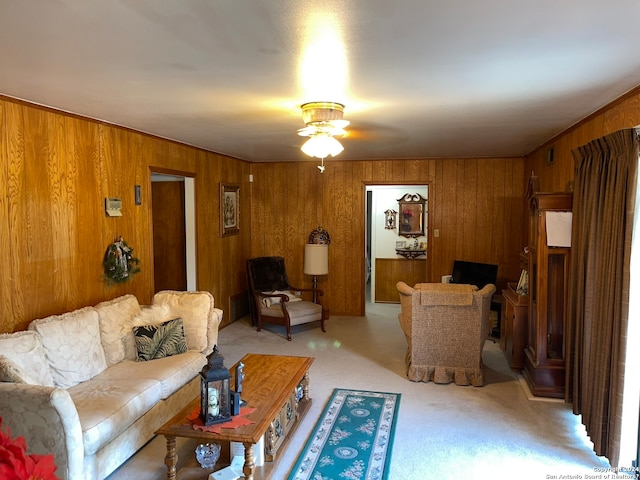 carpeted living room with wood walls