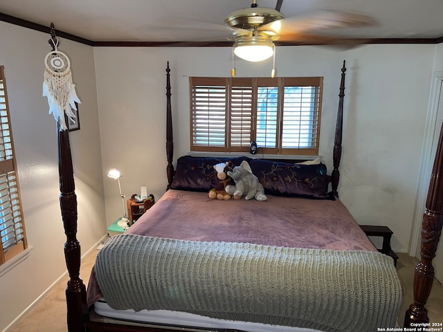 carpeted bedroom featuring ceiling fan and crown molding