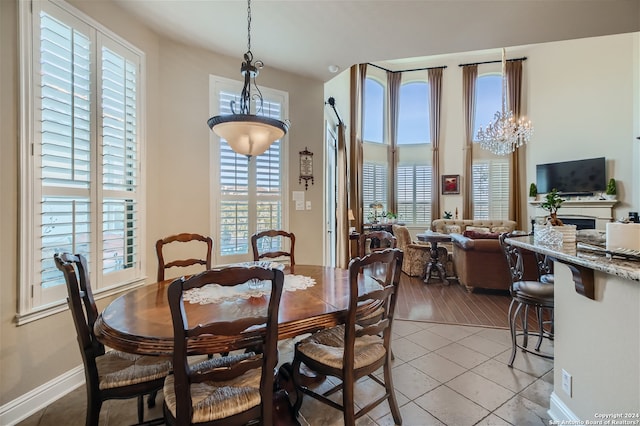 tiled dining area featuring a chandelier