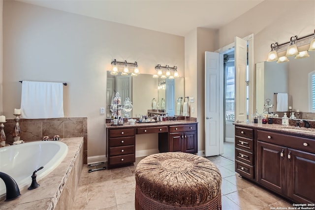 bathroom with double vanity, a relaxing tiled bath, and tile floors