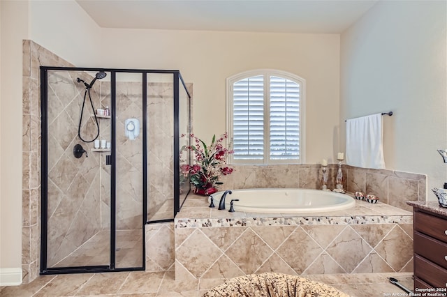 bathroom with tile floors, separate shower and tub, and vanity