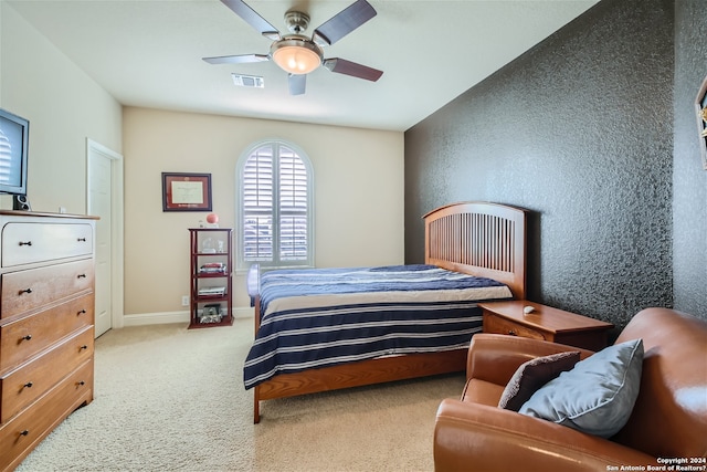 bedroom featuring light carpet and ceiling fan