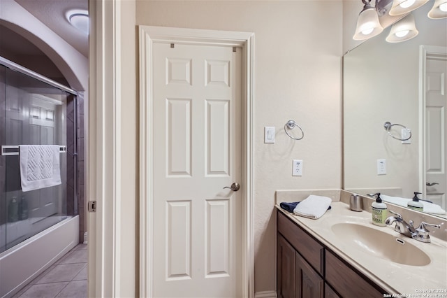 bathroom featuring tile floors, oversized vanity, and shower / washtub combination