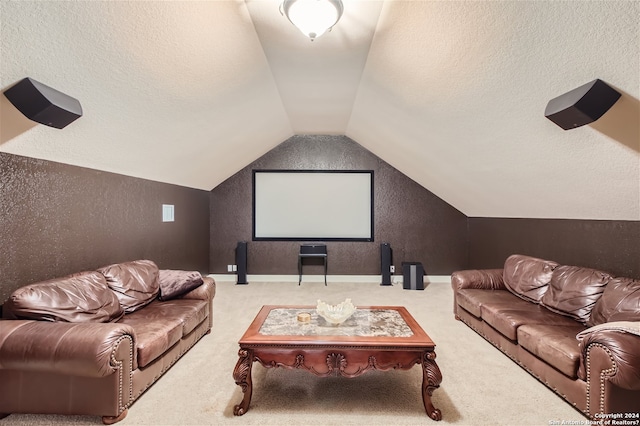 carpeted cinema featuring lofted ceiling and a textured ceiling