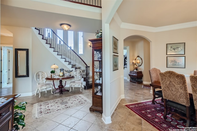 tiled entrance foyer with ornamental molding