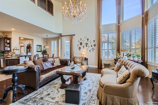 living room featuring dark hardwood / wood-style floors, an inviting chandelier, and a healthy amount of sunlight