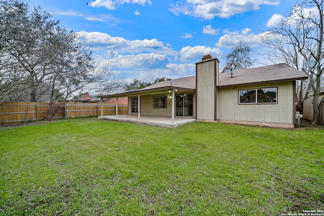 back of property with a patio and a yard