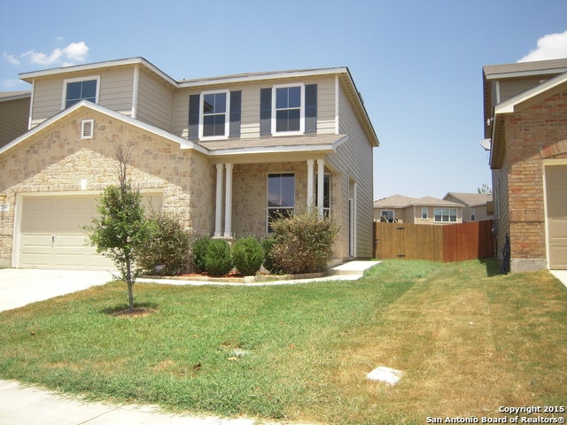 front of property with a front lawn and a garage